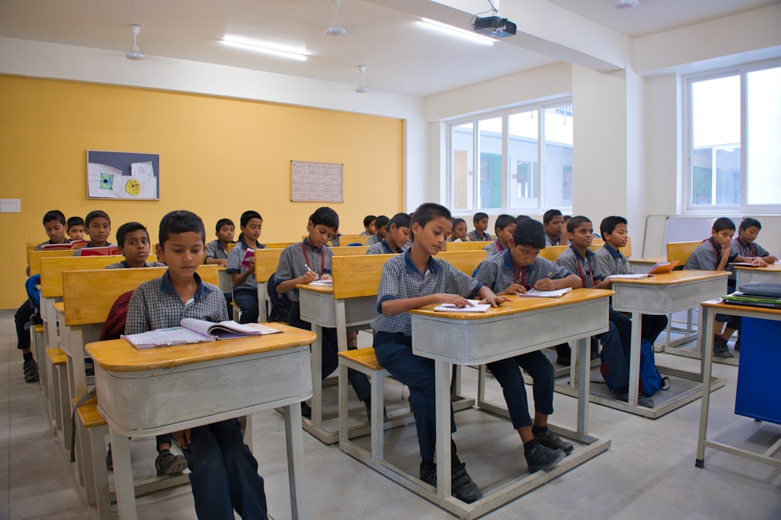 Children studying attentively at their desks in a classroom in India